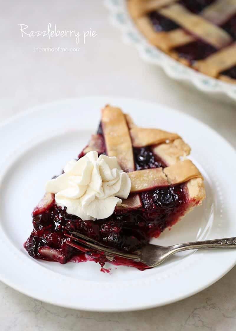 piece of razzleberry pie with whipped cream on a plate