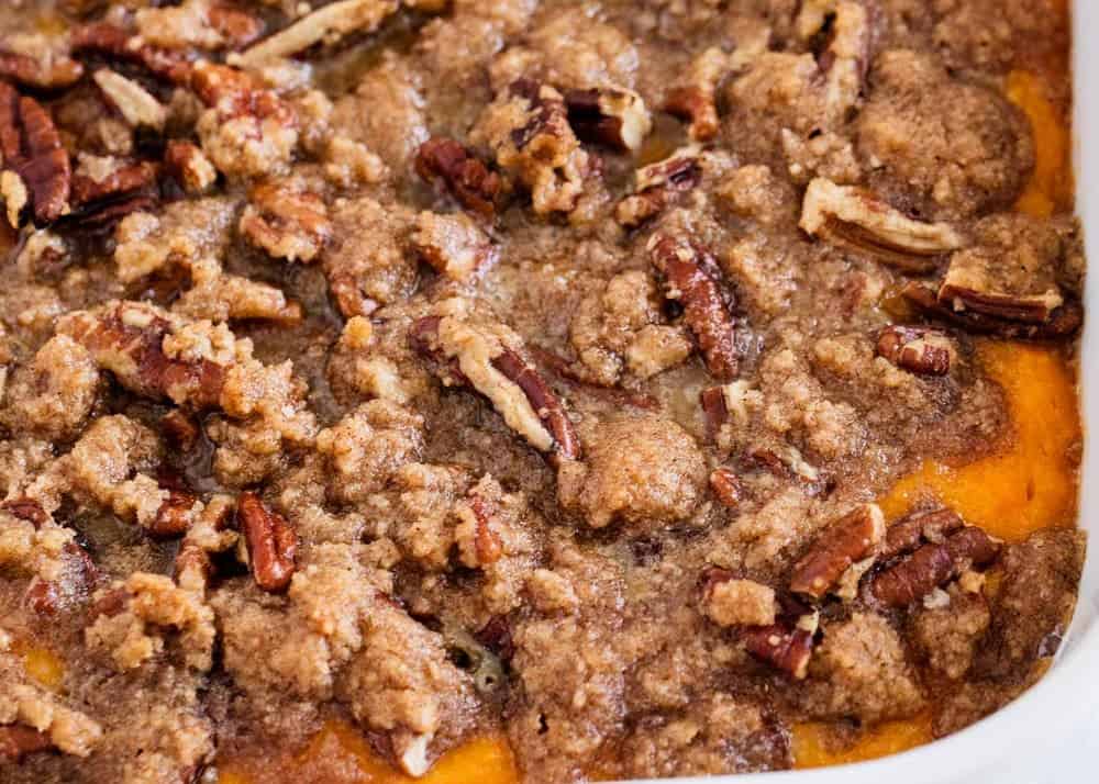 Mashed sweet potatoes topped with toasted pecans and a delicious brown sugar crumble. Add in marshmallows to make this sweet potato casserole the ultimate holiday side dish. Sweet potato casserole with pecans on top.