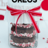 a container of peppermint oreos with a red ribbon