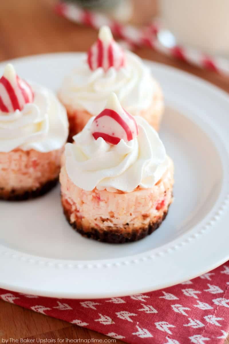 mini peppermint cheesecakes with whipped cream and a peppermint kiss 