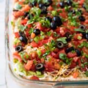 close up of 7 layer dip in a baking dish