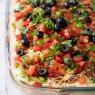 close up of 7 layer dip in a baking dish