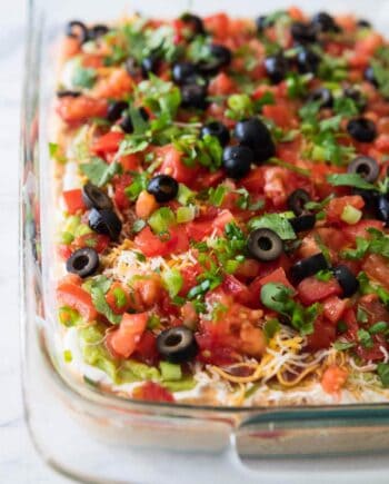 close up of 7 layer dip in a baking dish