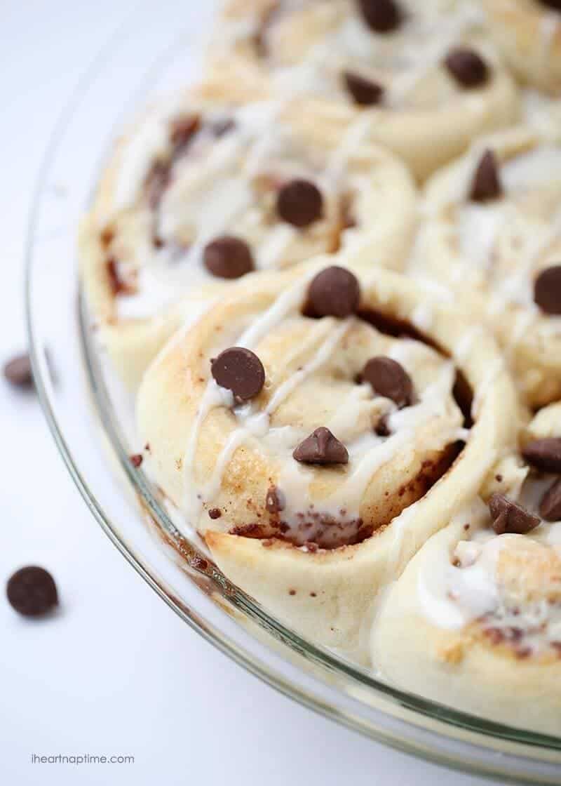 A close up of chocolate chip cinnamon rolls in pan 