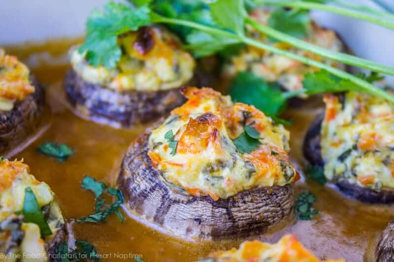 Asian stuffed mushrooms are the perfect side dish or appetizer. This stuffed mushroom recipe is filled with flavor thanks to a simple creamy stuffing and a 2-ingredient drizzle sauce. Close up of an asian stuffed mushroom.