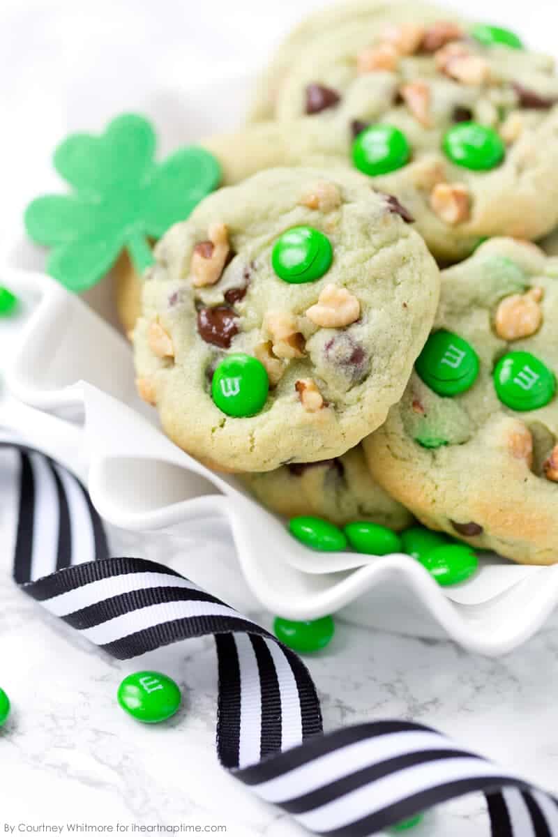 A close up of pistachio and chocolate chip cookies with green M&M\'s
