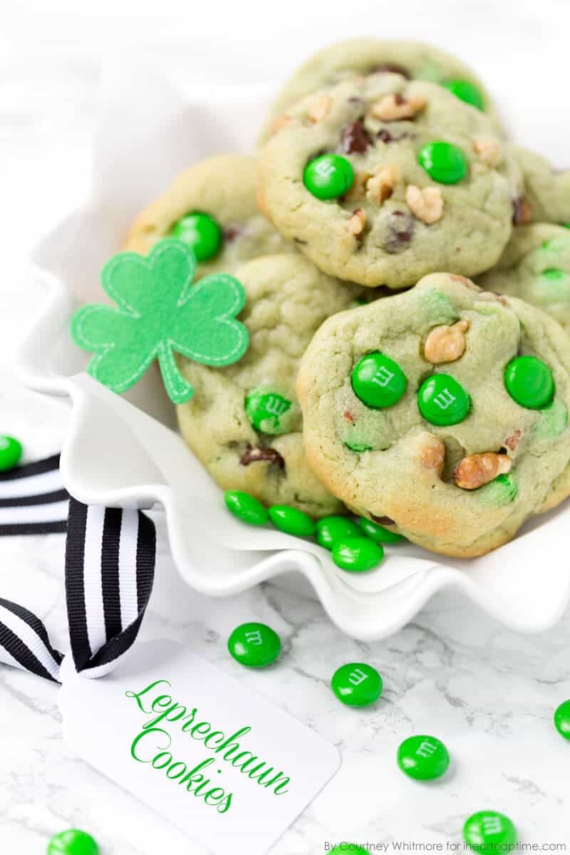 plate of pistachio chocolate chip cookies with green M&M\'s 