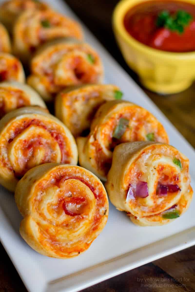 Pizza pinwheels on a white plate.