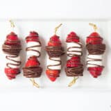 chocolate strawberry dessert kabobs on a white serving plate