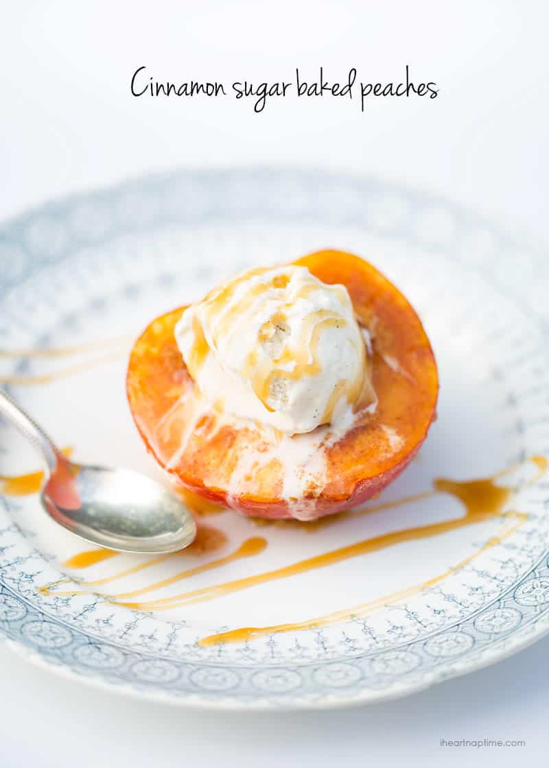 Baked peach on a plate topped with ice cream and caramel.