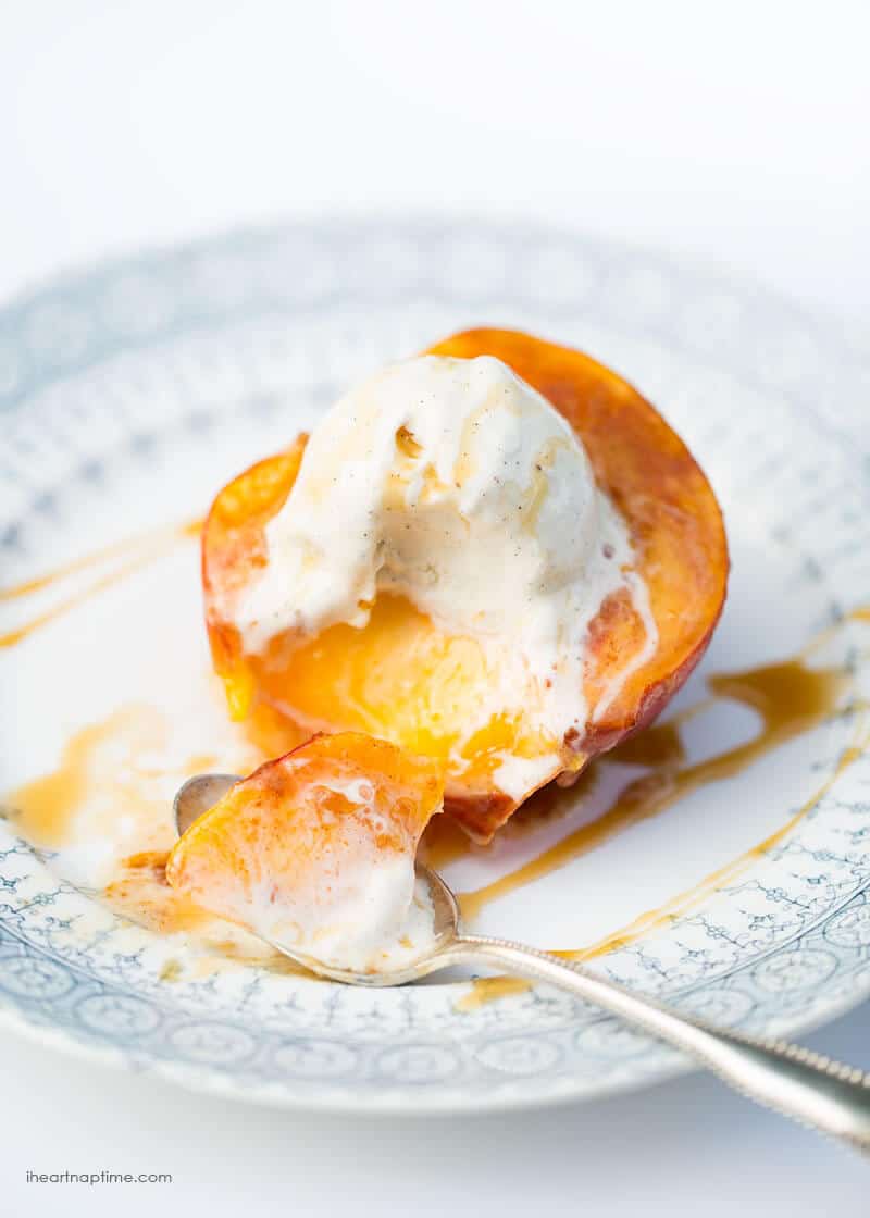 Baked peach on a plate with a bite taken out. 