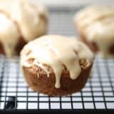 A close up of a maple glazed snickerdoodle muffin on cooling rack