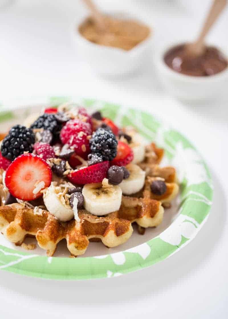 Waffle topped with fresh berries, coconut and chocolate chips.