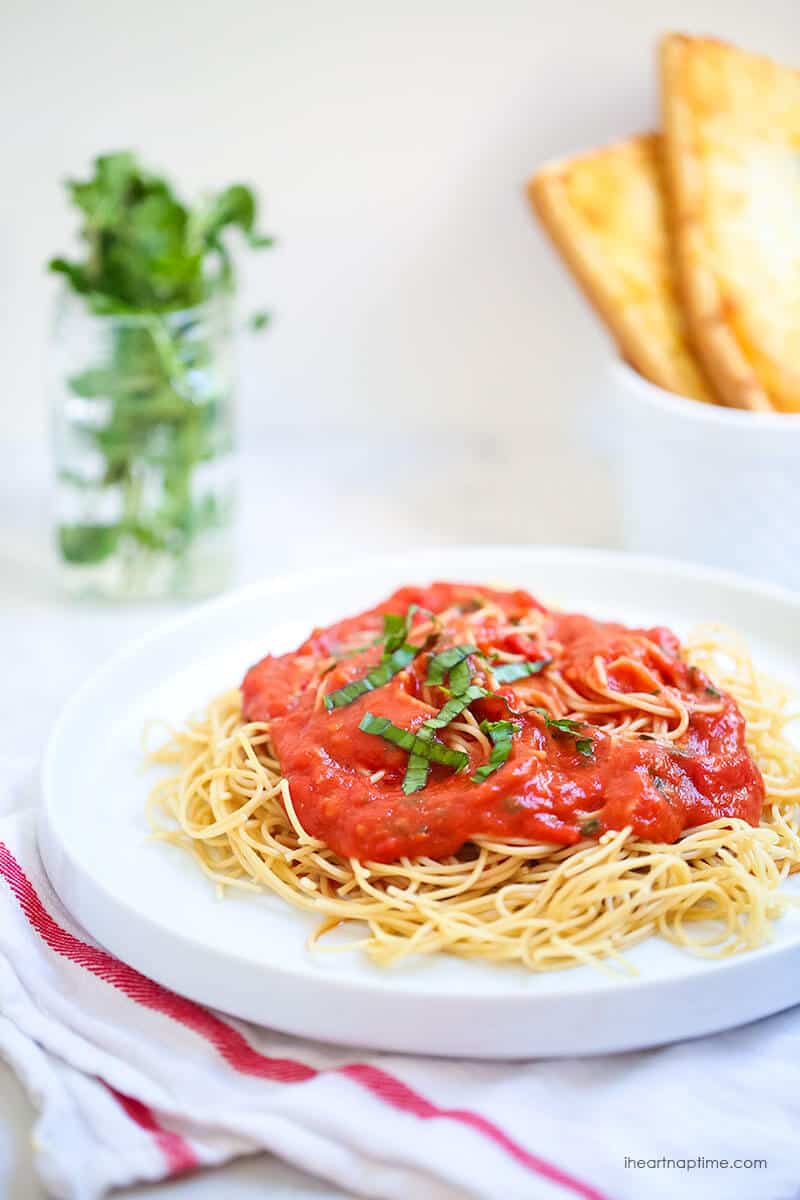 Plate of spaghetti with roasted tomato sauce on top.