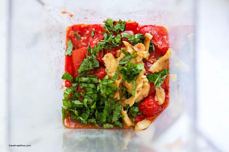 roasted tomatoes, garlic and basil being blended in the blender