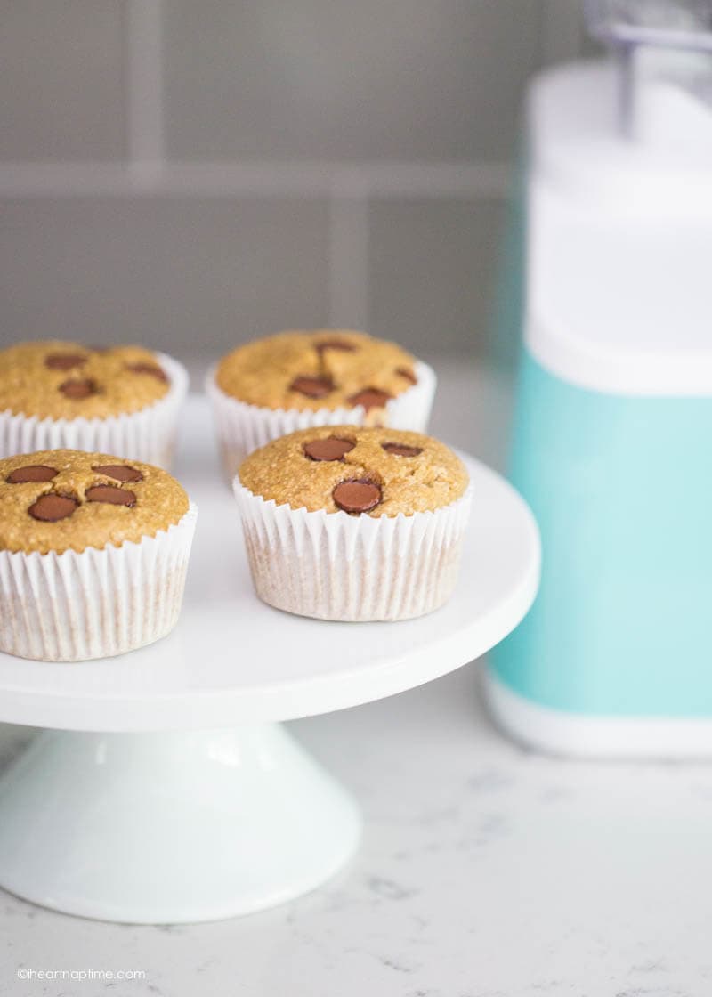 banana oatmeal muffins on a white cake stand with chocolate chips on top 