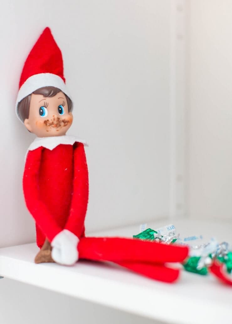 Top 50 of the BEST Elf on the Shelf ideas - So many fun ideas to do with your Elf leading up to Christmas! Your family will love these list amazing list of elf ideas! Elf eating chocolate