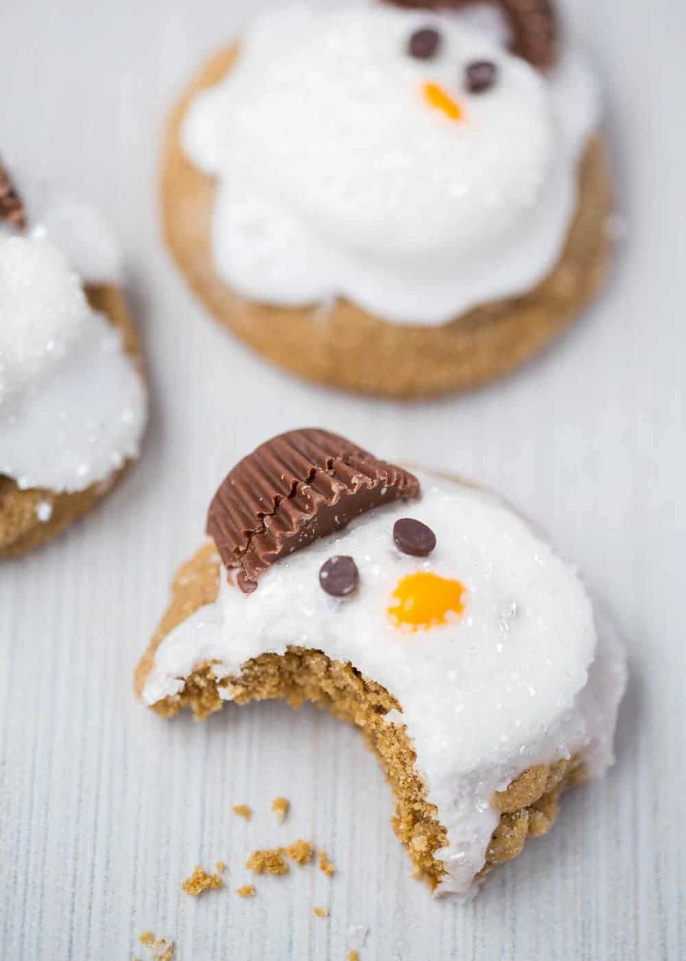 Snowman cookies with a bite taken out.