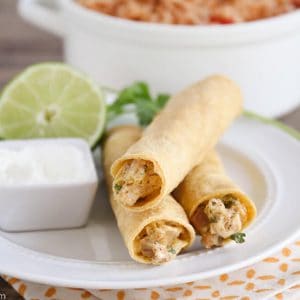 Creamy Chicken Taquitos - an easy and delicious crock pot meal teaming a creamy, delectable chicken mixture with Tex Mex spices. A perfect dinner for busy weeknights!