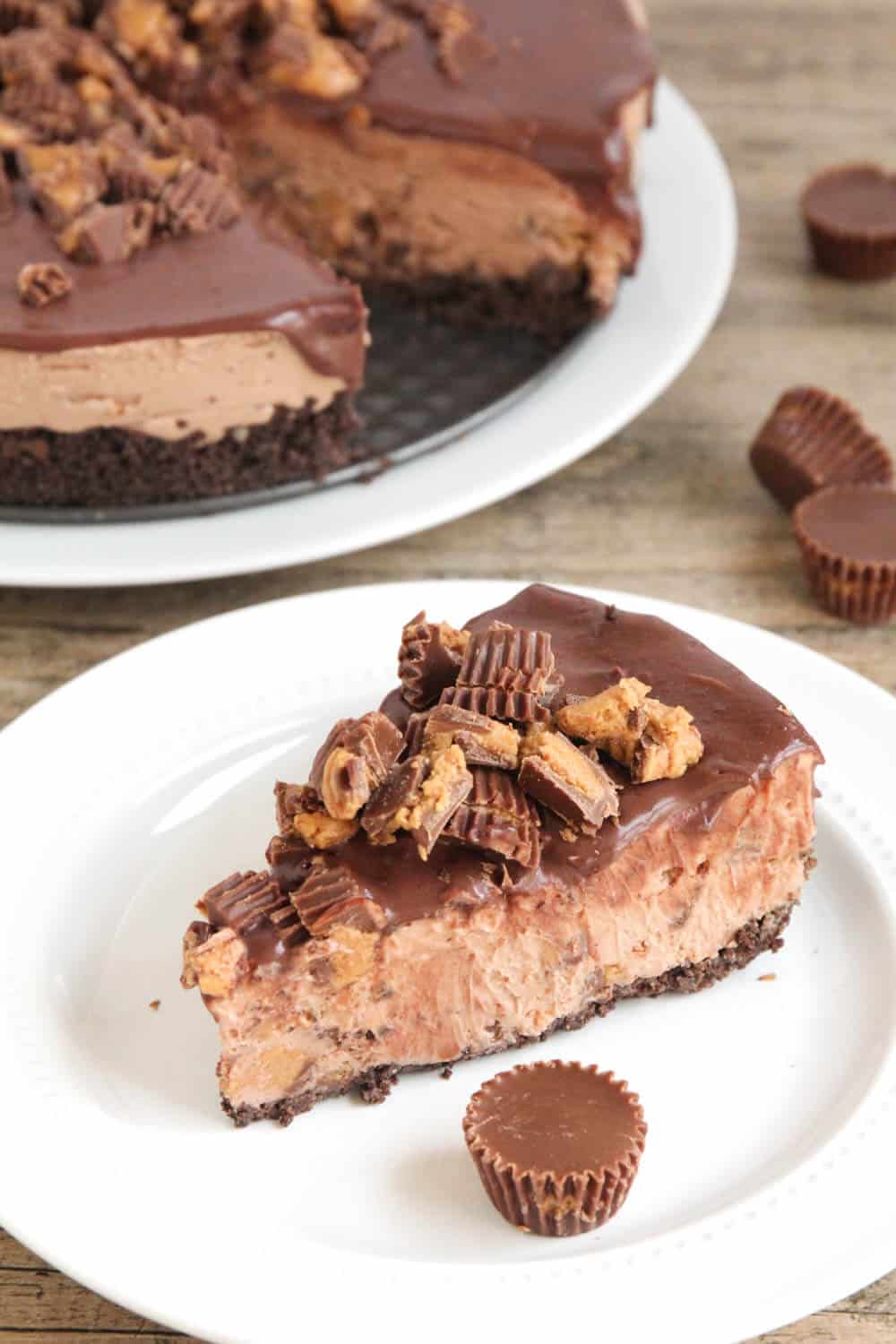 Slice of Reese's cheesecake on white plate.