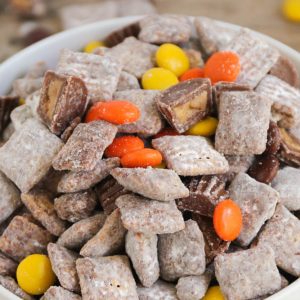 Reese's Muddy Buddies - a fun twist on the classic favorite with the addition of Reese's Peanut Butter Cups and Reese's Pieces! Such an easy treat that is loved by kids and adults!