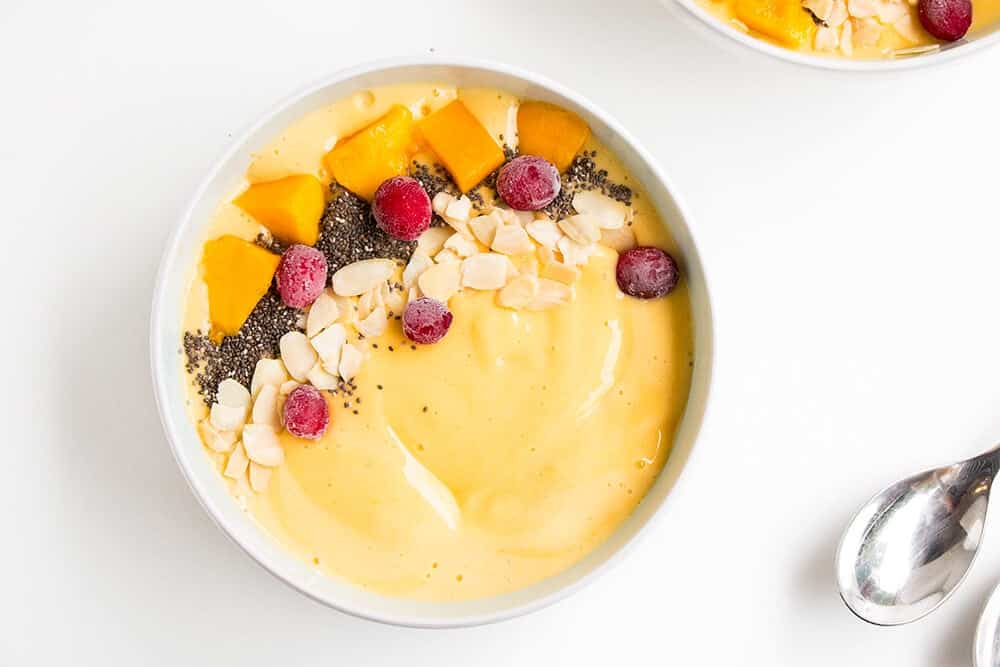 Mango smoothie bowl with toppings.