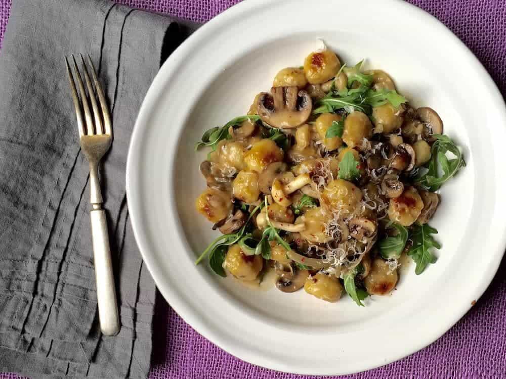 Easy Parmesan Mushroom Gnocchi - A family pleaser and comforting for a chilly winter night. It's simple to put together with store-bought helpers like sliced mushrooms and packaged gnocchi, but tastes like date night out.