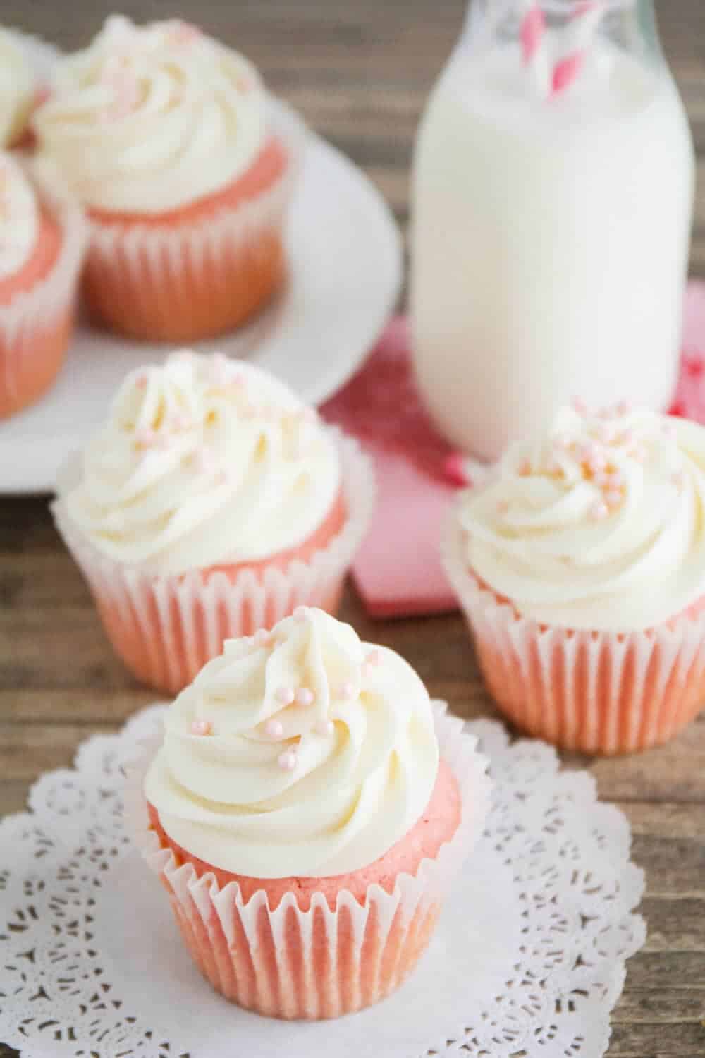 Pink cupcakes with cream cheese frosting and pink sprinkles.