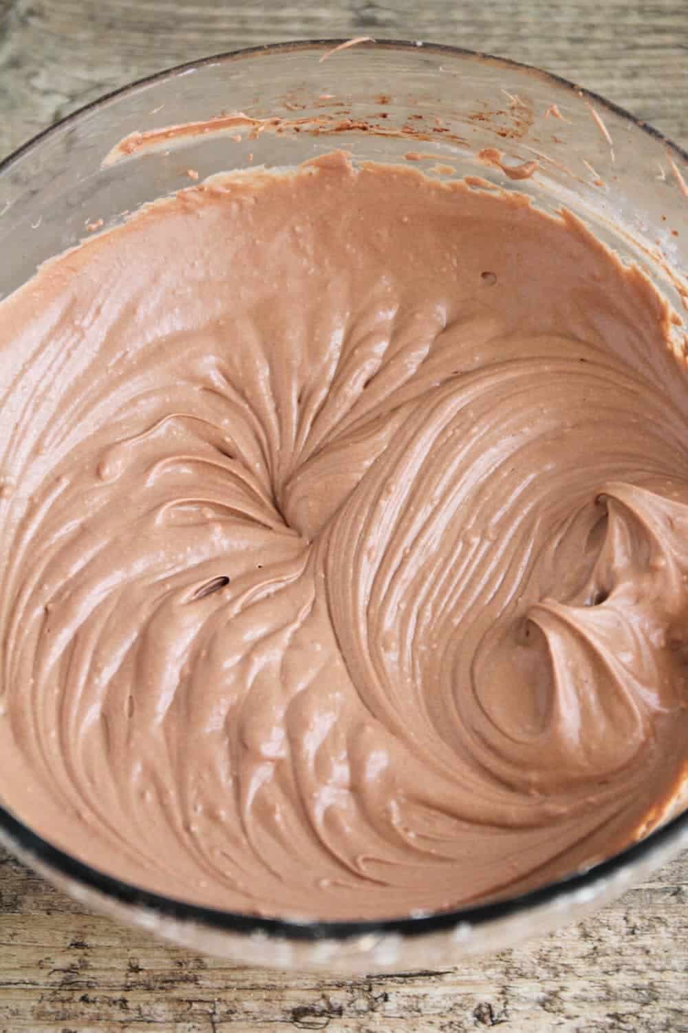 Peanut butter cheesecake filling in a glass bowl.