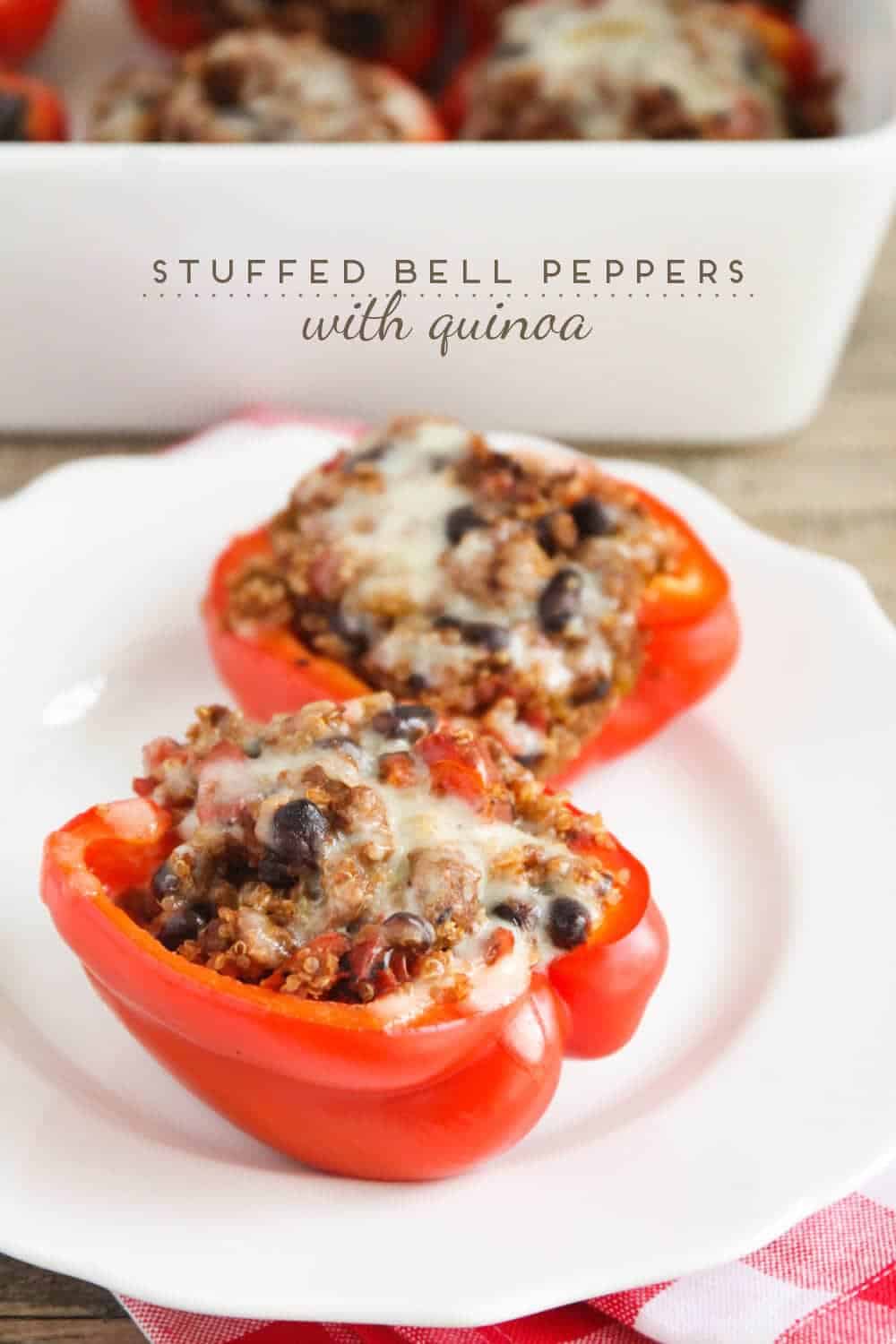 Quinoa stuffed bell peppers on a white plate.
