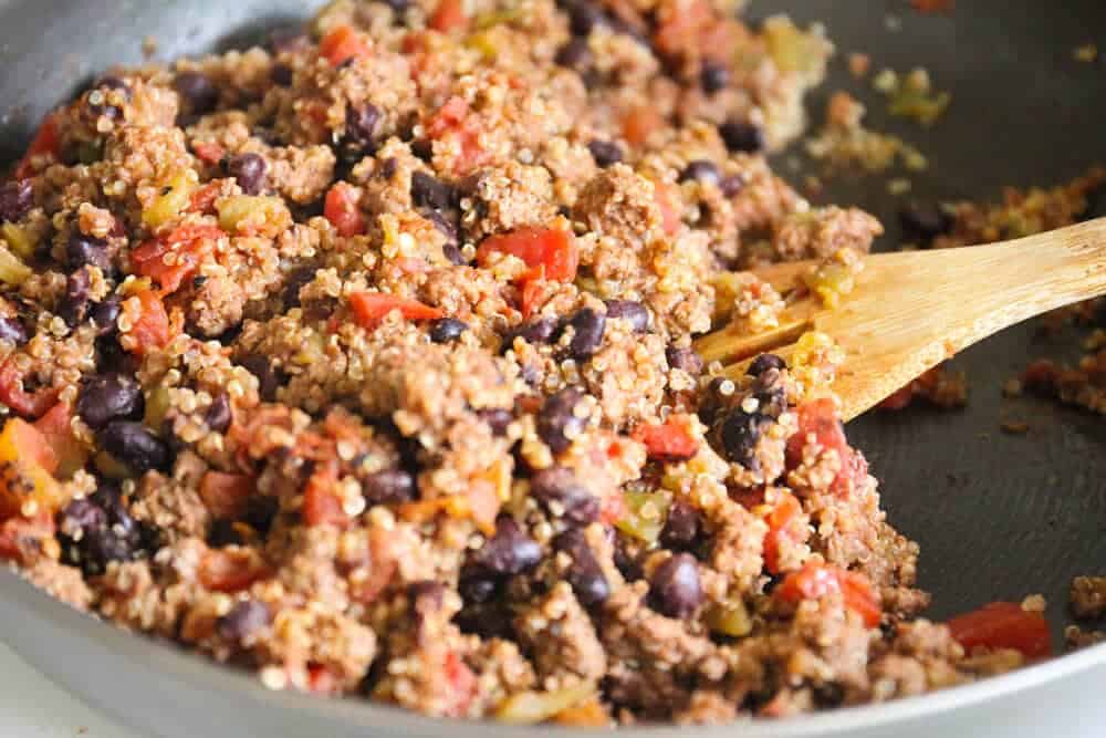 cooking filling on stove for quinoa stuffed peppers 