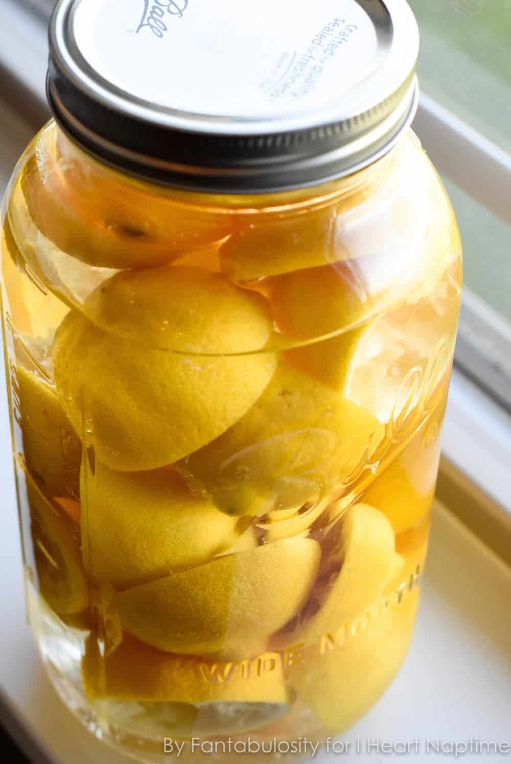 Large mason jar full of lemon vinegar cleaner.