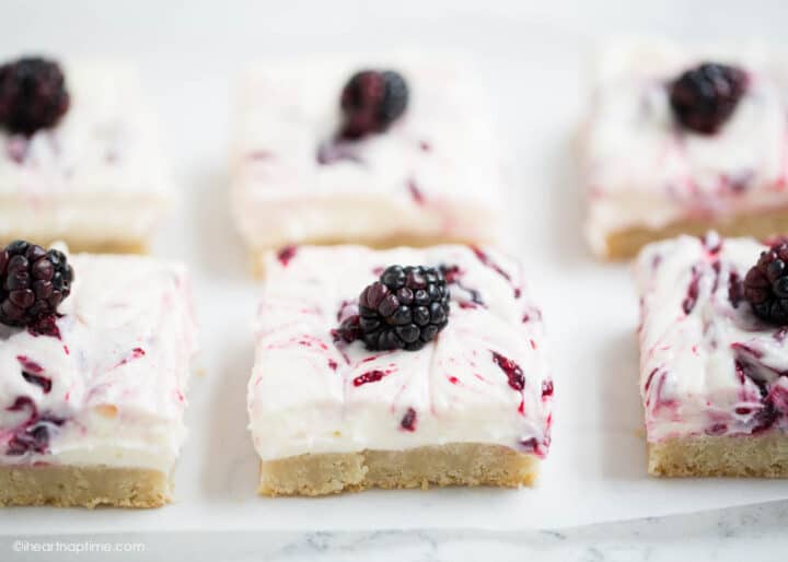 blackberry cheesecake bars with a fresh blackberry on top 