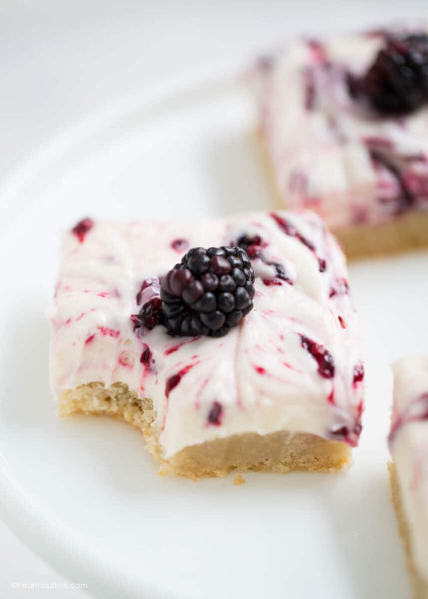 blackberry cheesecake bar with a bite taken out 