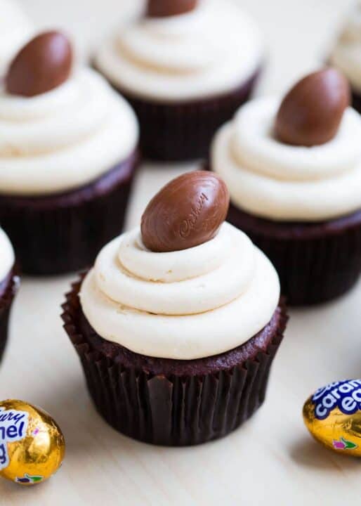 A colorful array of Easter cupcakes with bunny, carrot, and chocolate decorations, perfect for Easter dessert ideas.