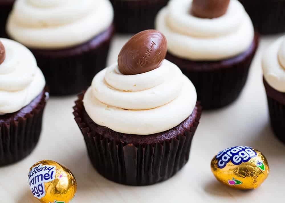 Frosted Easter cupcakes with Cadbury egg on top.