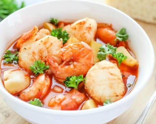 Slow Cooker Seafood Stew - a delicious seafood recipe cooked in a tomato-based broth with potatoes. This stew is comforting and is an easy to make dinner recipe!