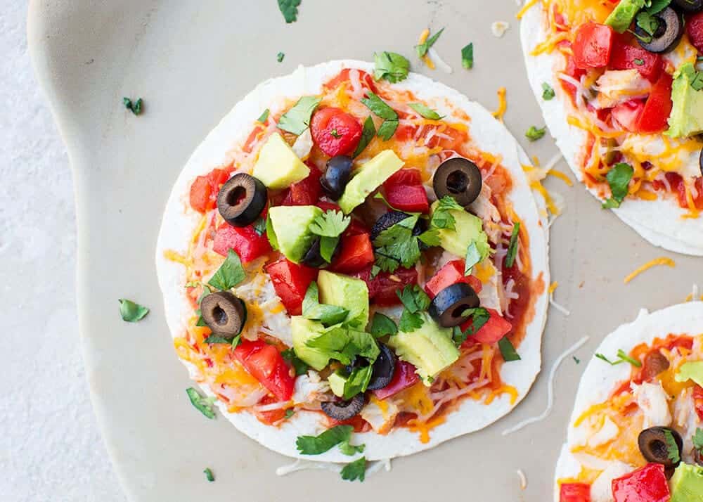 Delicious warm tortillas stuffed with refried beans, meat and melty cheese. Add your favorite toppings and there you have it...a yummy Mexican pizza made in just minutes! mexican pizza