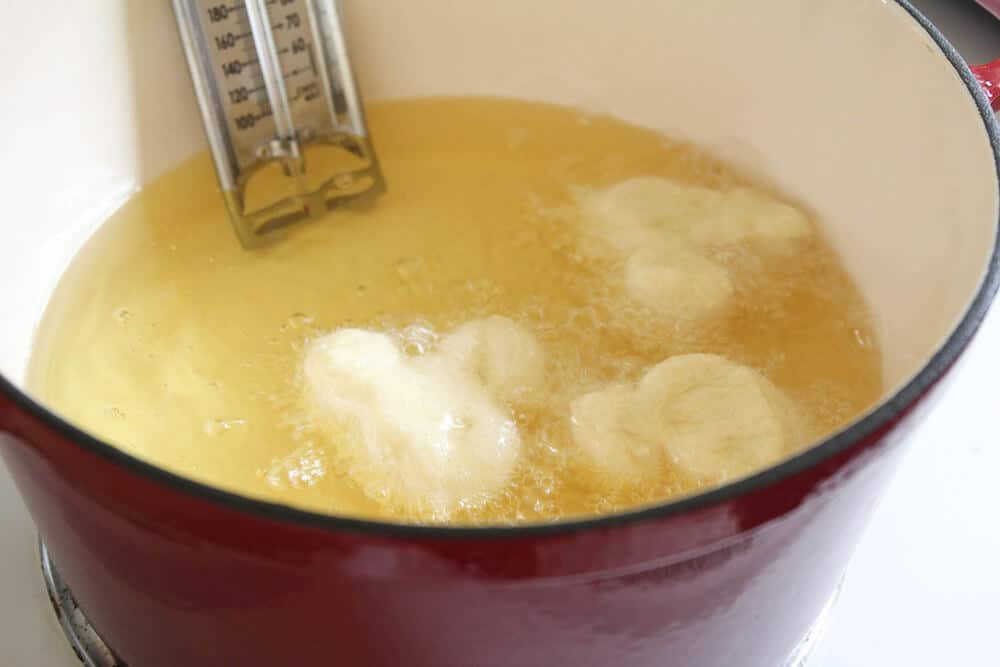 frying mickey beignets in oil 