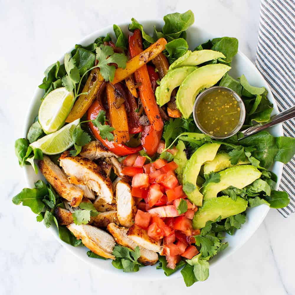 Chicken fajita salad in white bowl.