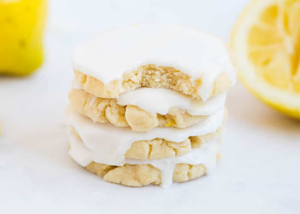 Lemon glazed cookies stacked on top of each other.
