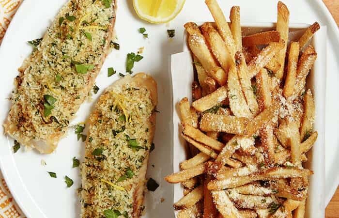 Crispy Lemon Baked Fish with Parmesan Fries - incredibly easy to cook oven! It's topped with a simple citrus and herb-seasoned panic breadcrumbs so there's no dredging and frying. A generous sprinkling of Parmesan spruces up frozen fries to make the perfect accompaniment.