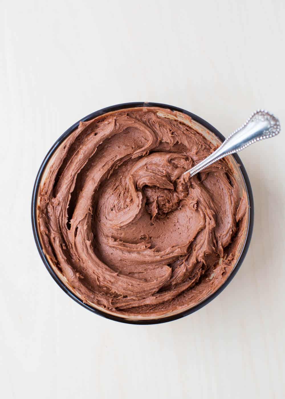 Chocolate buttercream in a glass bowl. 