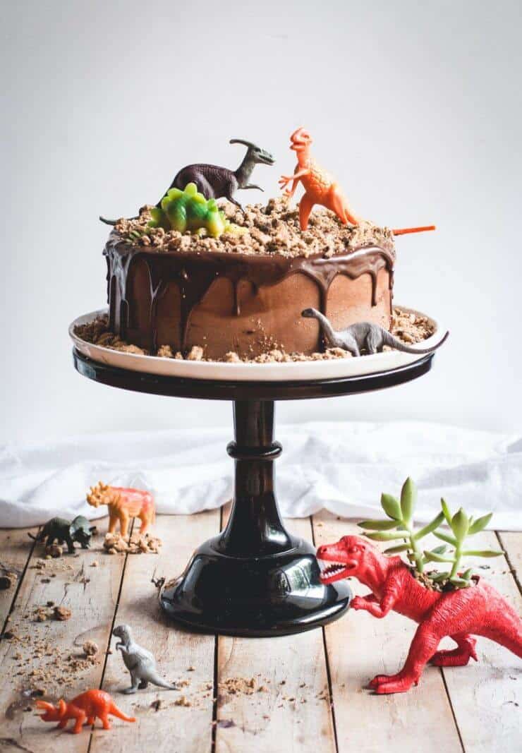 chocolate dinosaur cake on a cake stand 