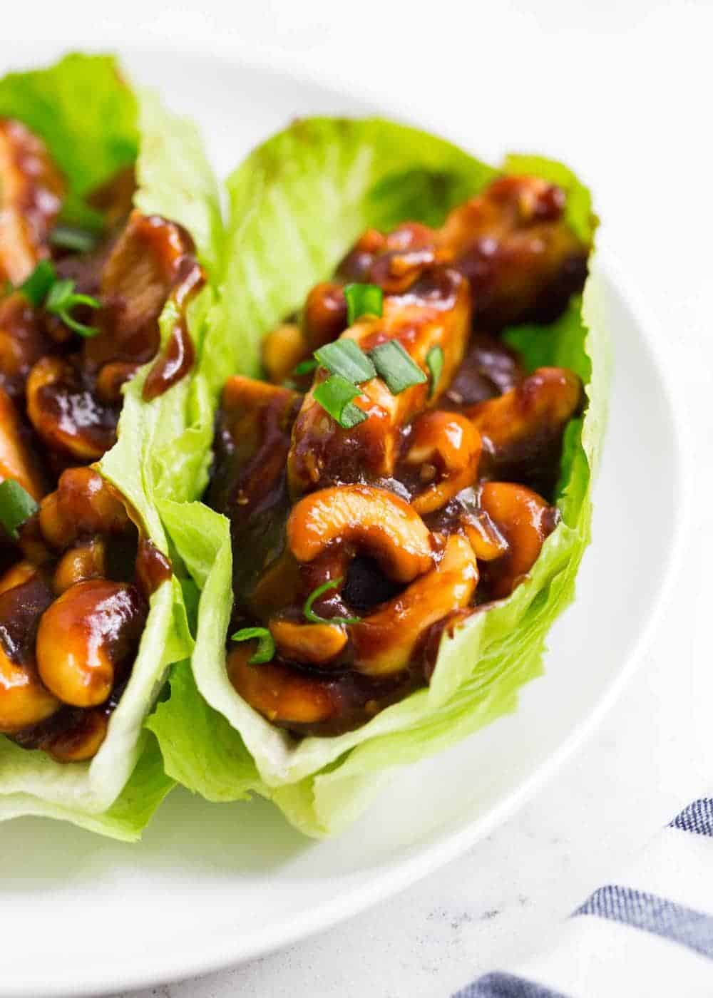 Close up of cashew chicken in lettuce wraps.