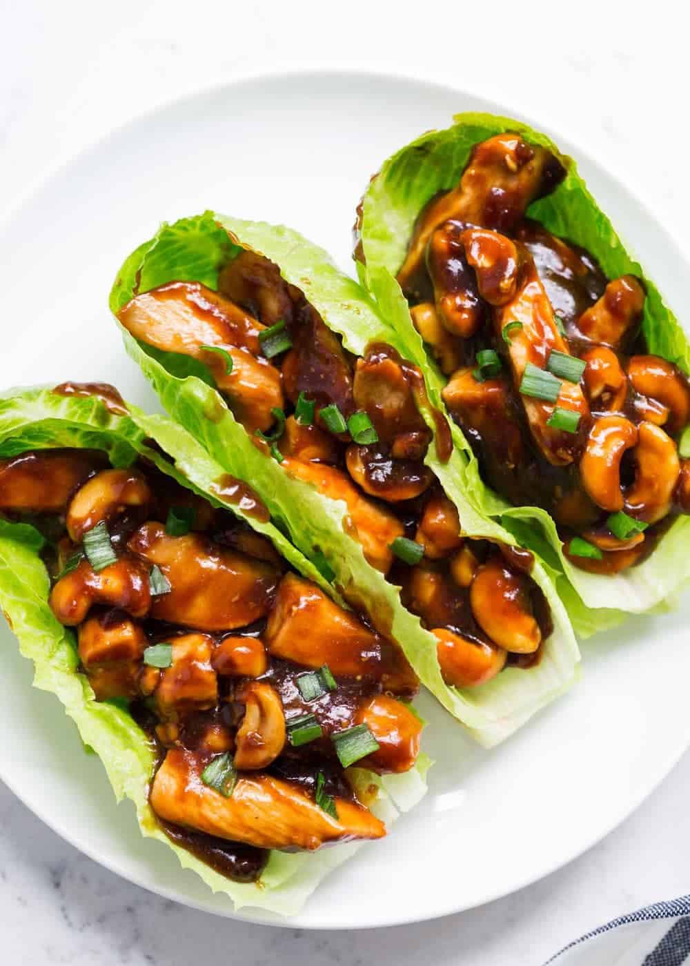 Cashew chicken lettuce wraps on plate.