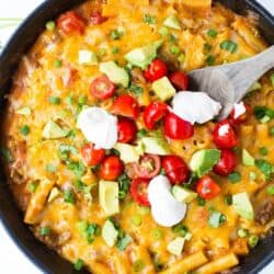 This ONE POT cheesy enchilada pasta recipe is so simple and completely delicious. It's done in 30 minutes from start to finish and is a family favorite!