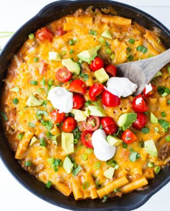 This ONE POT cheesy enchilada pasta recipe is so simple and completely delicious. It's done in 30 minutes from start to finish and is a family favorite!