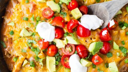 This ONE POT cheesy enchilada pasta recipe is so simple and completely delicious. It's done in 30 minutes from start to finish and is a family favorite!