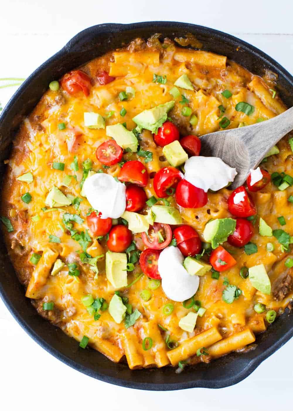 One pot of Enchilada pasta with a wooden spoon.